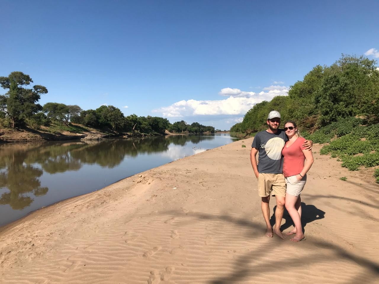 Amy and Andrew on a sunny sandy riverbank